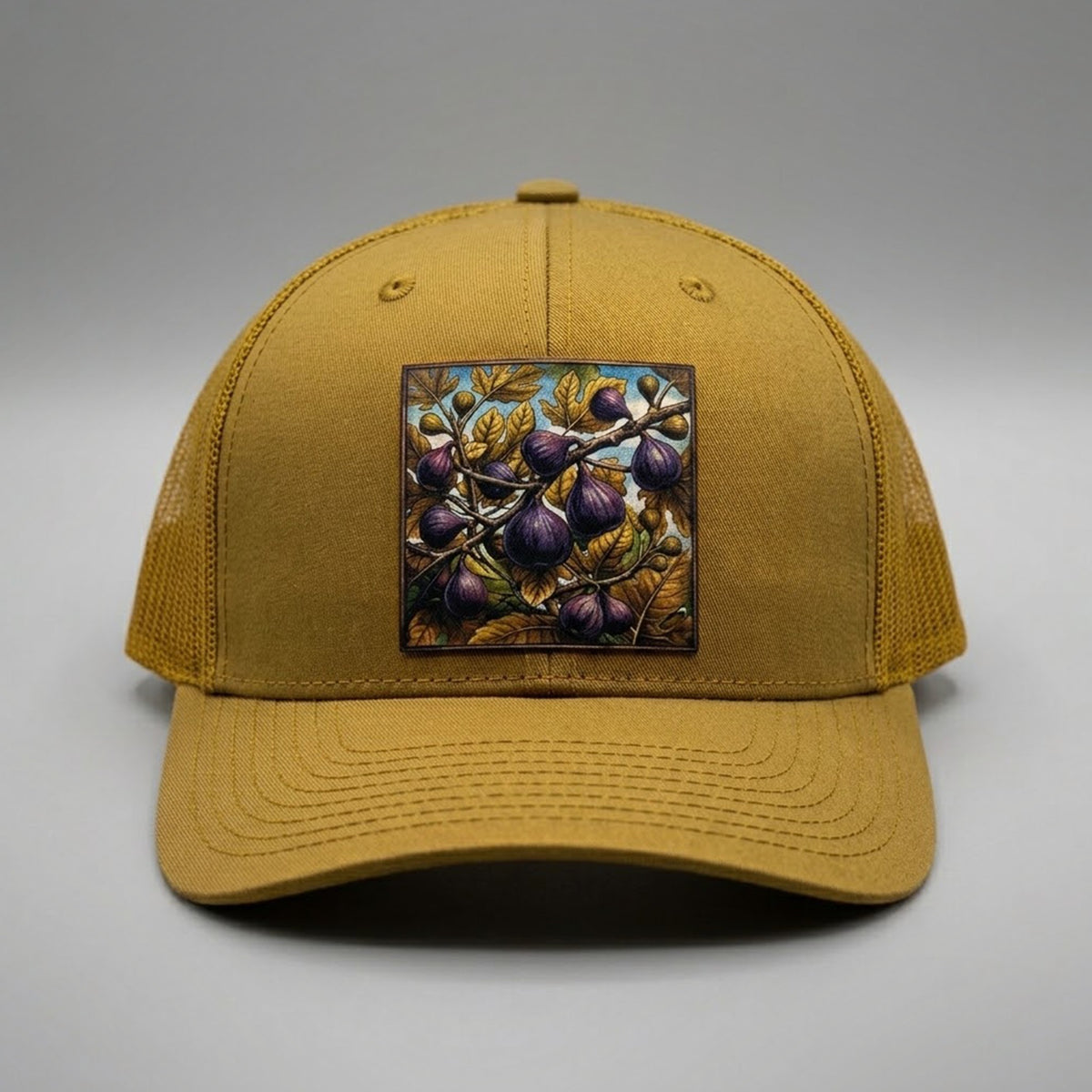Figs trucker hat in biscuit gold, front view, patch of ripe purple figs on the branch
