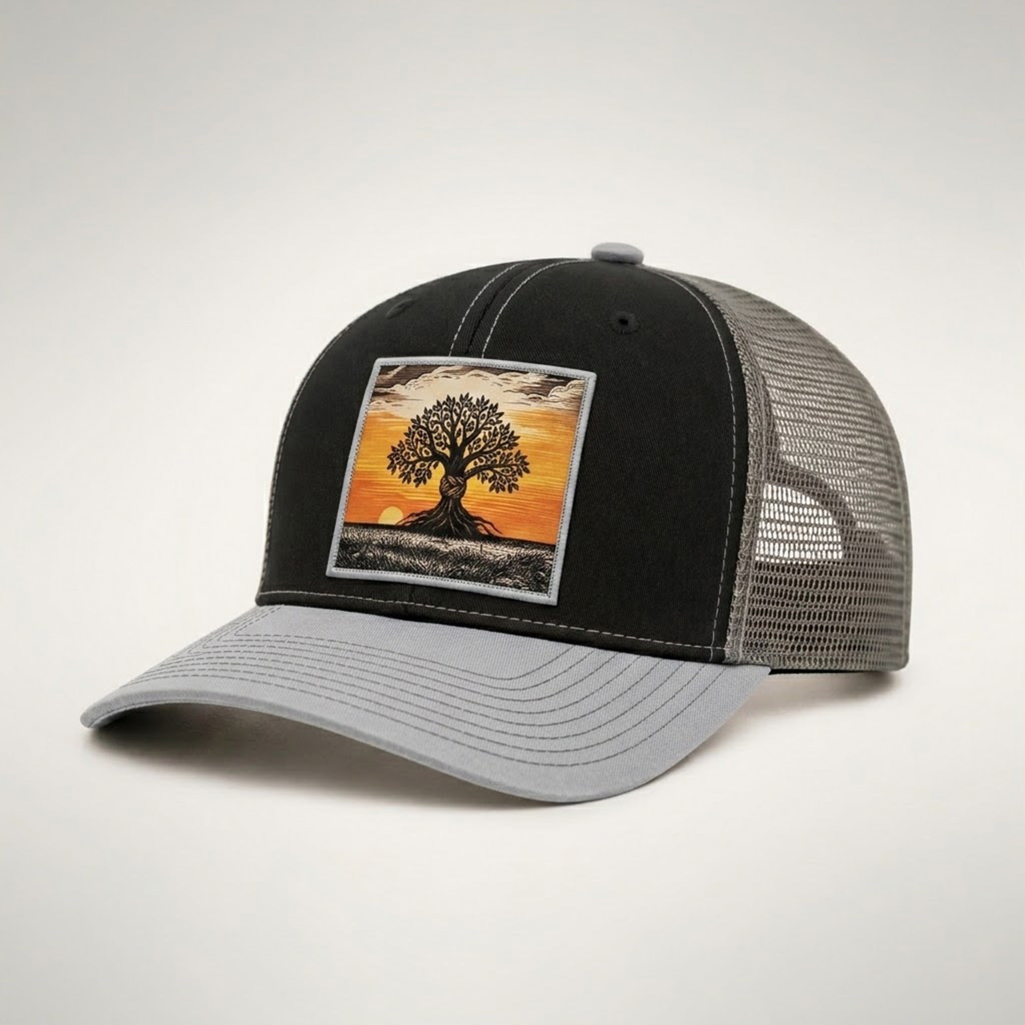 Graphe trucker hat in black and grey, side view showing the grey mesh back and light grey pre-curved bill