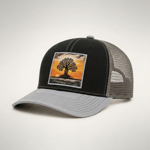 Graphe trucker hat in black and grey, side view showing the grey mesh back and light grey pre-curved bill