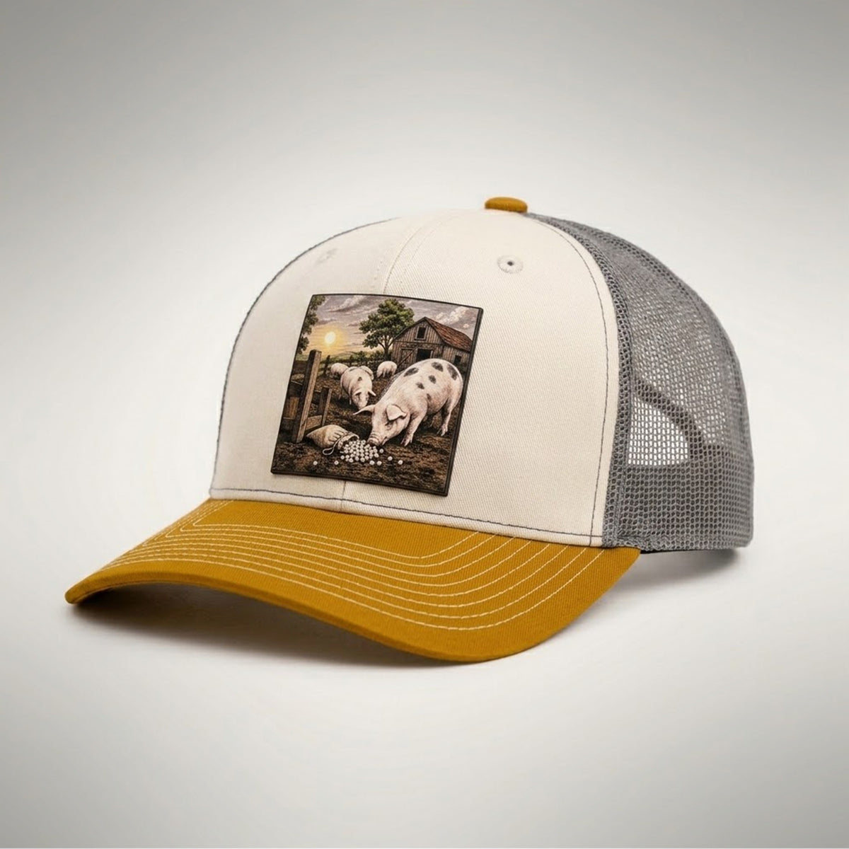 Pearls and Swine trucker hat in birch and gold, side view showing the grey mesh back and gold pre-curved bill