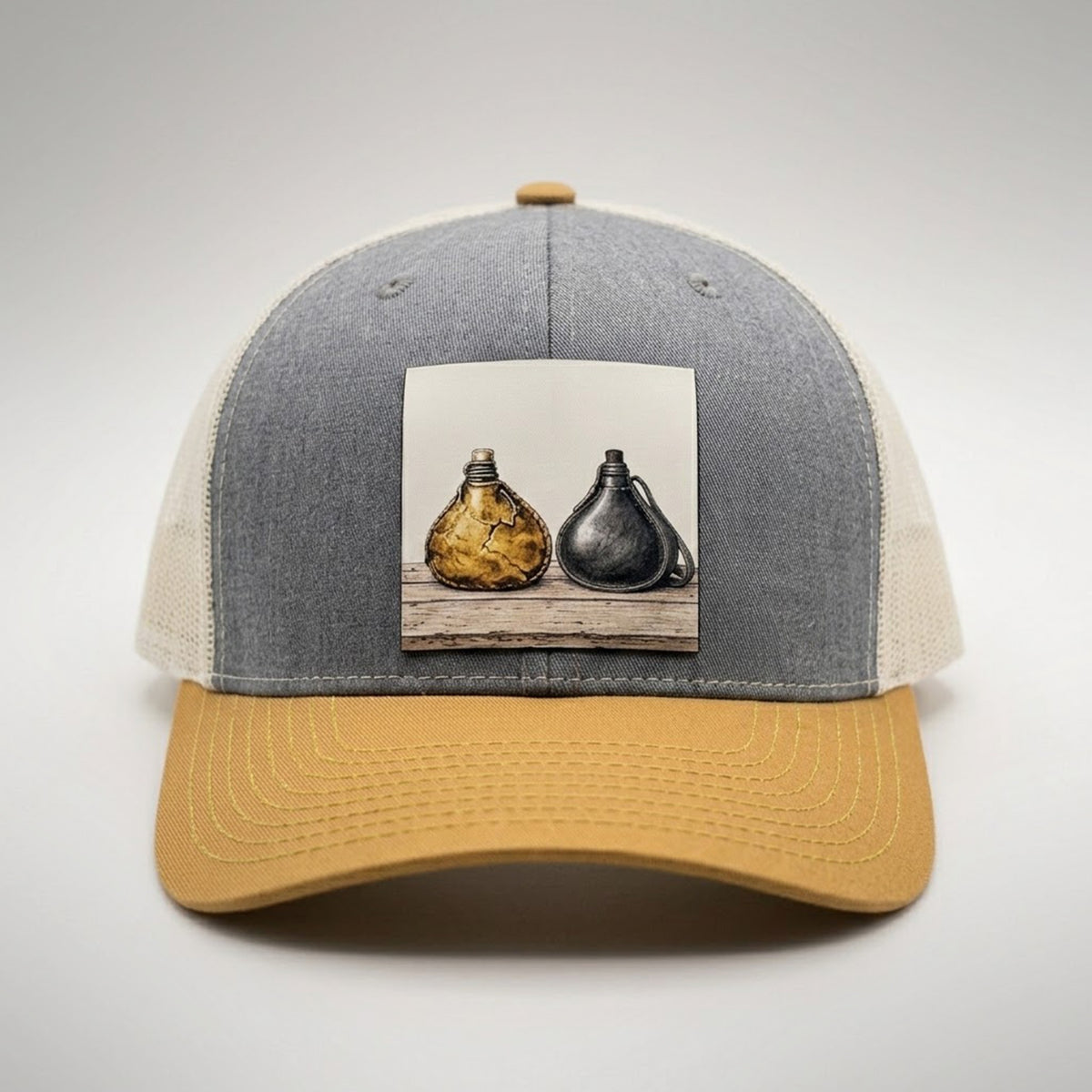 Wineskins trucker hat in heather grey and biscuit, front view, patch of an old wineskin beside a new one